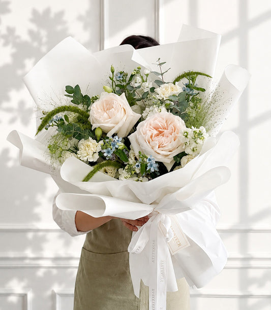 A luxurious Flowers by Basketeer bouquet featuring blush garden roses, white spray