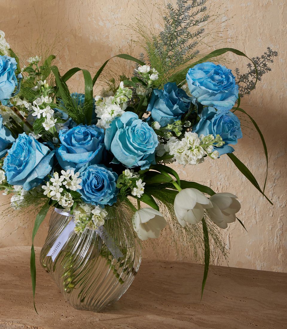 Premium blue roses and white flowers in clear glass vase, elegant fresh arrangement for gifting