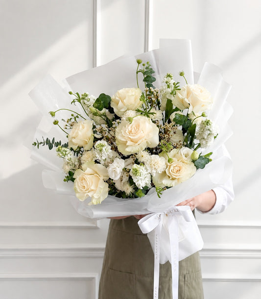 Elegant white rose bouquet by Flowers by Basketeer, featuring lush cream roses, delicate