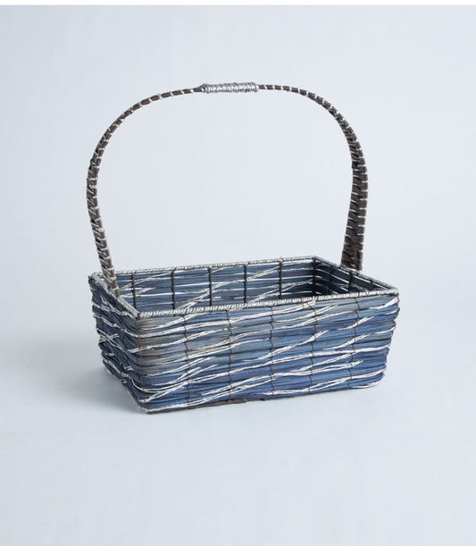 Blue and grey woven gift basket with silver-metal trim and brown handle