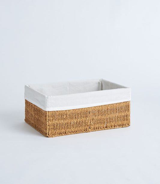 Handwoven rectangular wicker basket with natural fiber weave and removable white linen liner