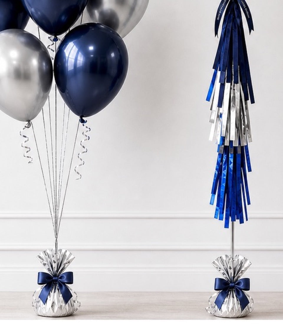 Navy and silver balloons with coordinating tassel garland and balloon weight decorations on white background.