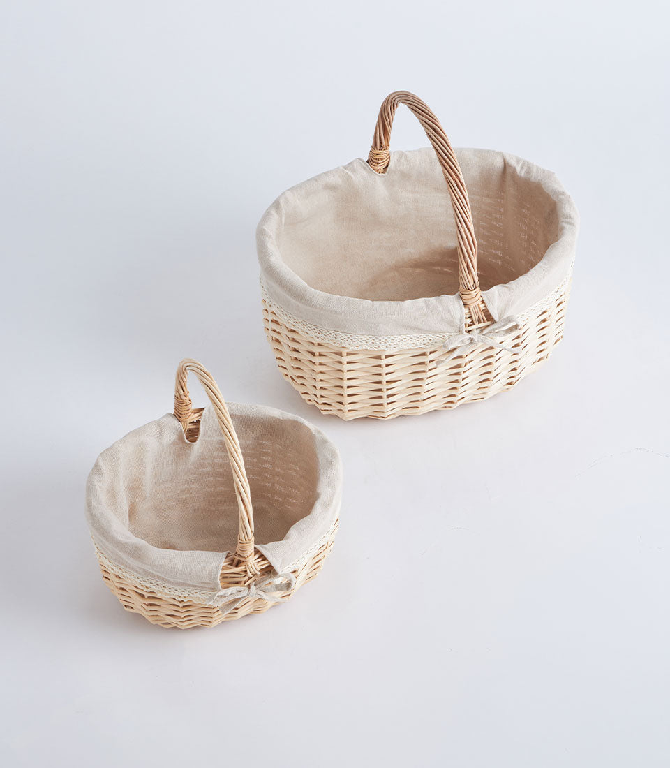 Handwoven wicker baskets with light beige fabric lining and white lace trim, available in two sizes