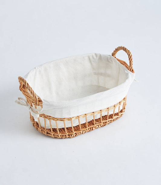 Natural wicker oval basket with rope handles and white fabric liner