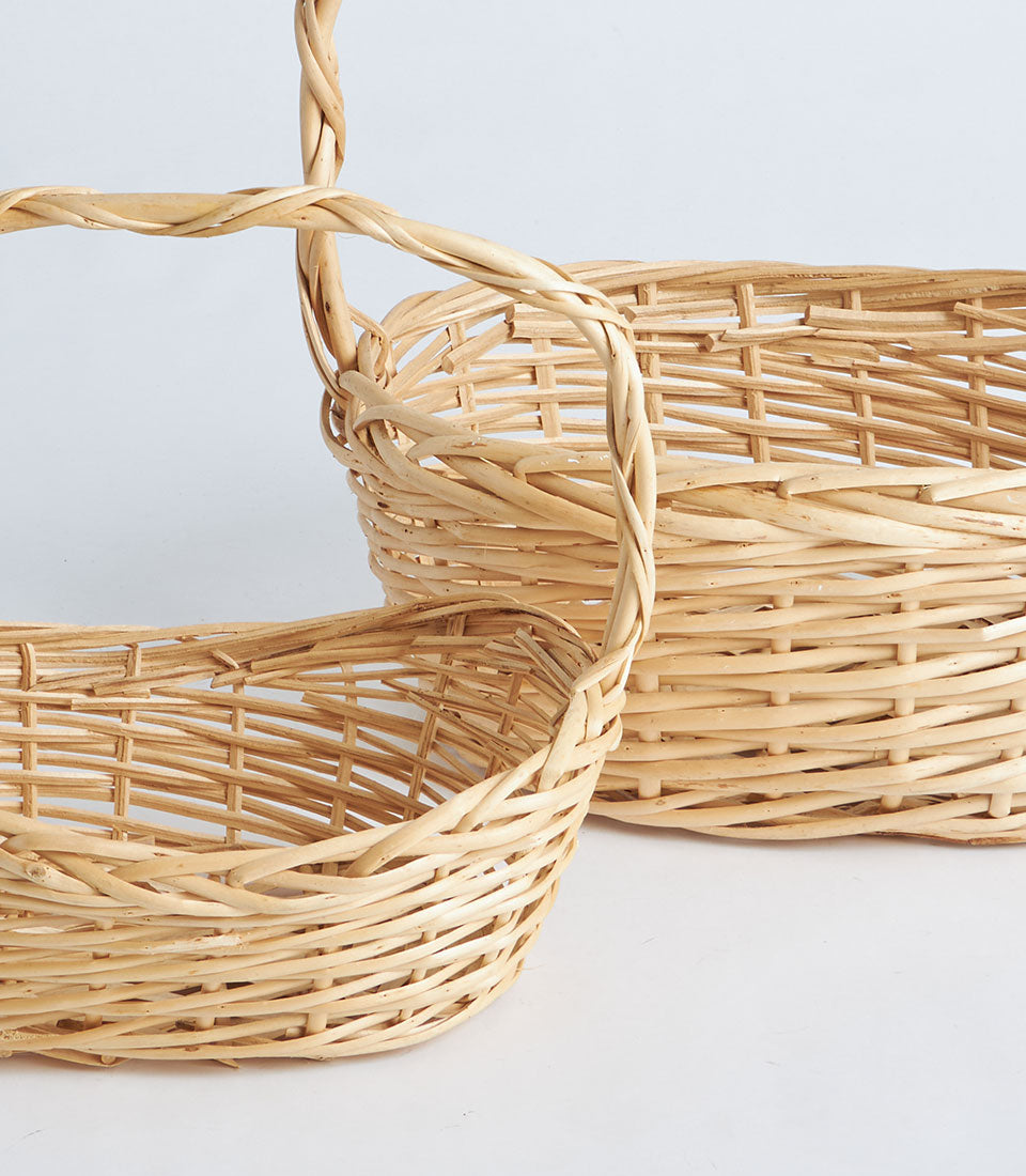 Natural woven wicker oval baskets with twisted handles for premium gift hampers