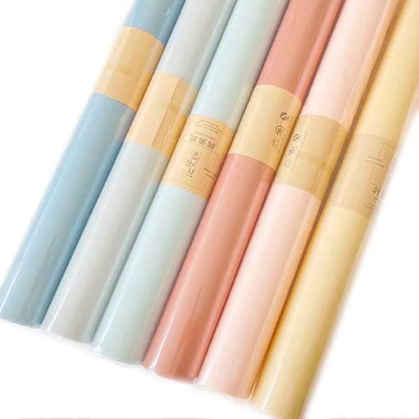 Pastel wrapping paper rolls in blue, grey, teal, terracotta, pink and yellow