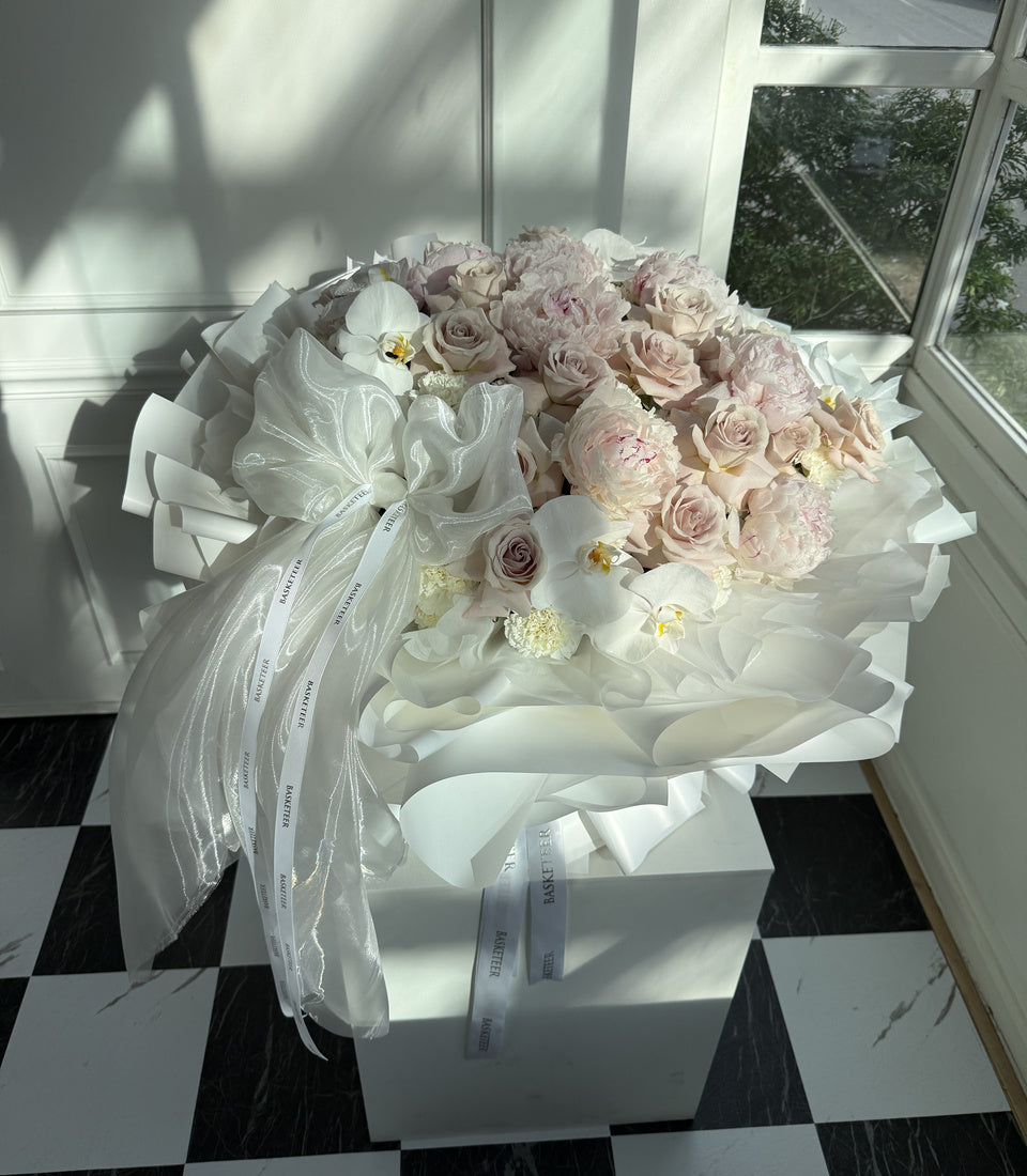 Angled window-side view of luxury pink peony rose orchid bouquet