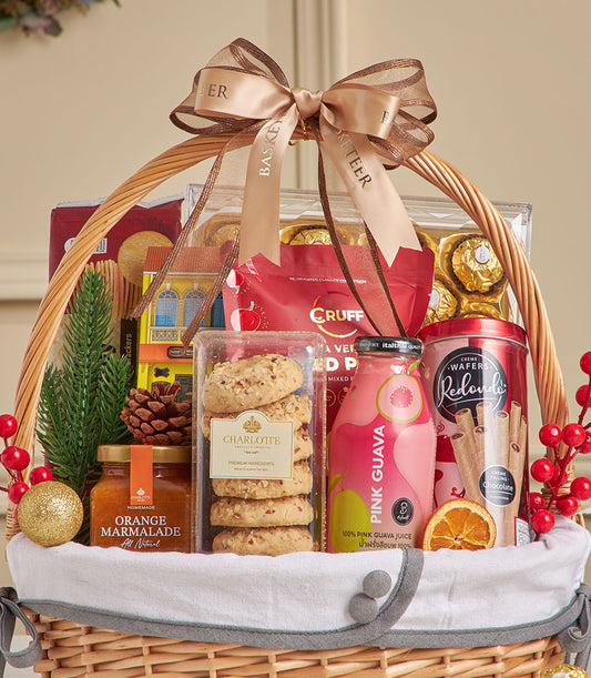 Woven wicker gift basket with spiced guava juice, chocolate wafers, cookies, and gourmet treats tied with gold ribbon, New