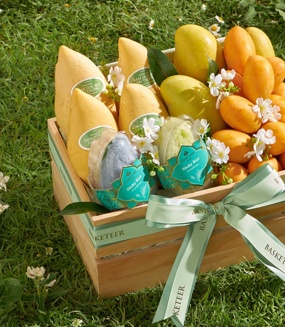 Premium Nam Dok Mai and orange mangoes with sticky rice in handcrafted wooden basket