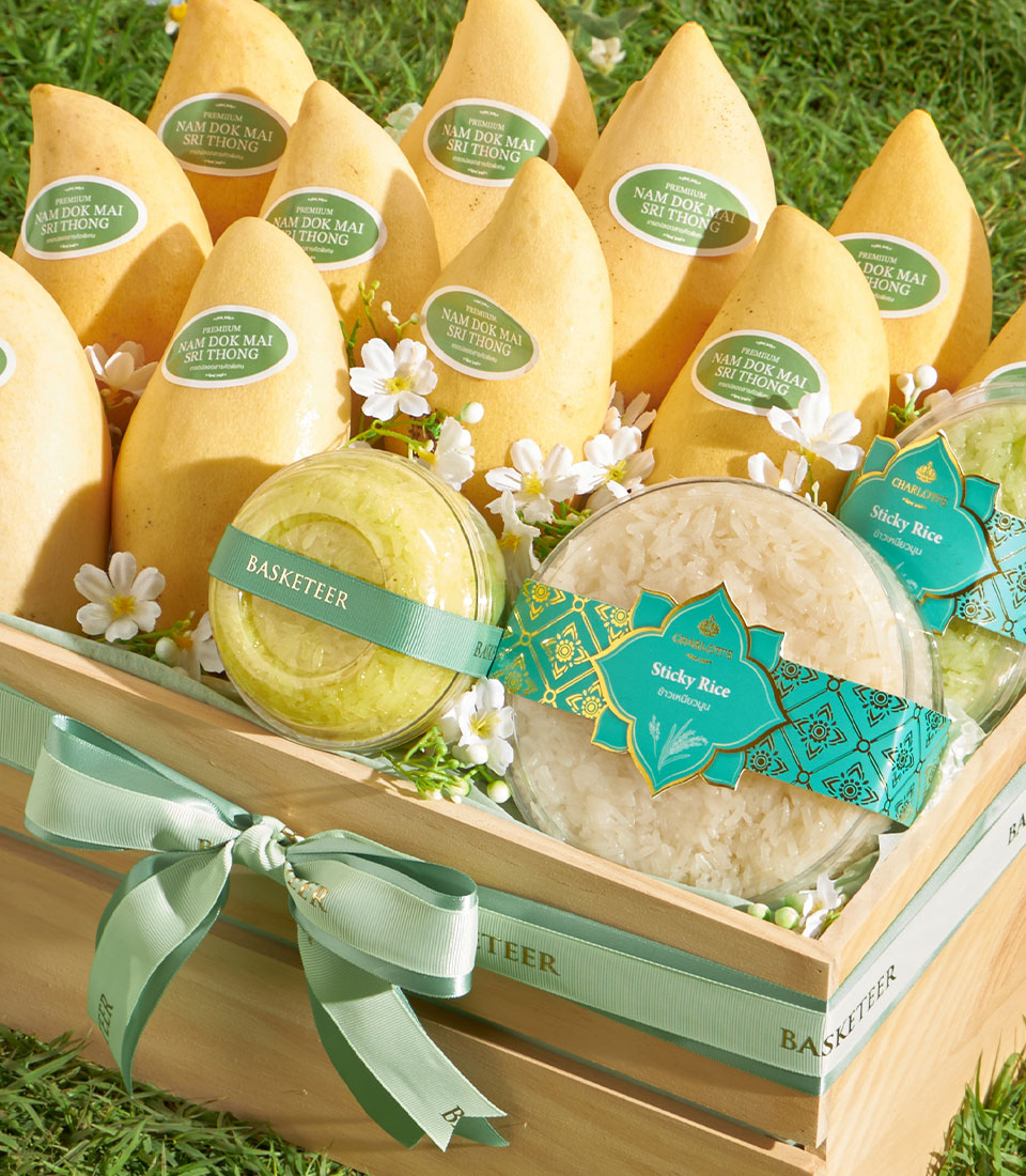 Premium Nam Dok Mai mango gift basket with sticky rice and fresh white flowers on green satin ribbon
