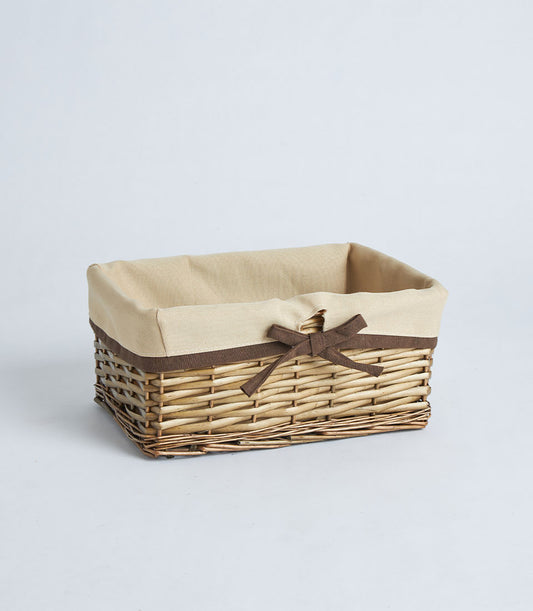 Natural wicker rectangular basket with beige fabric lining and dark brown ribbon bow