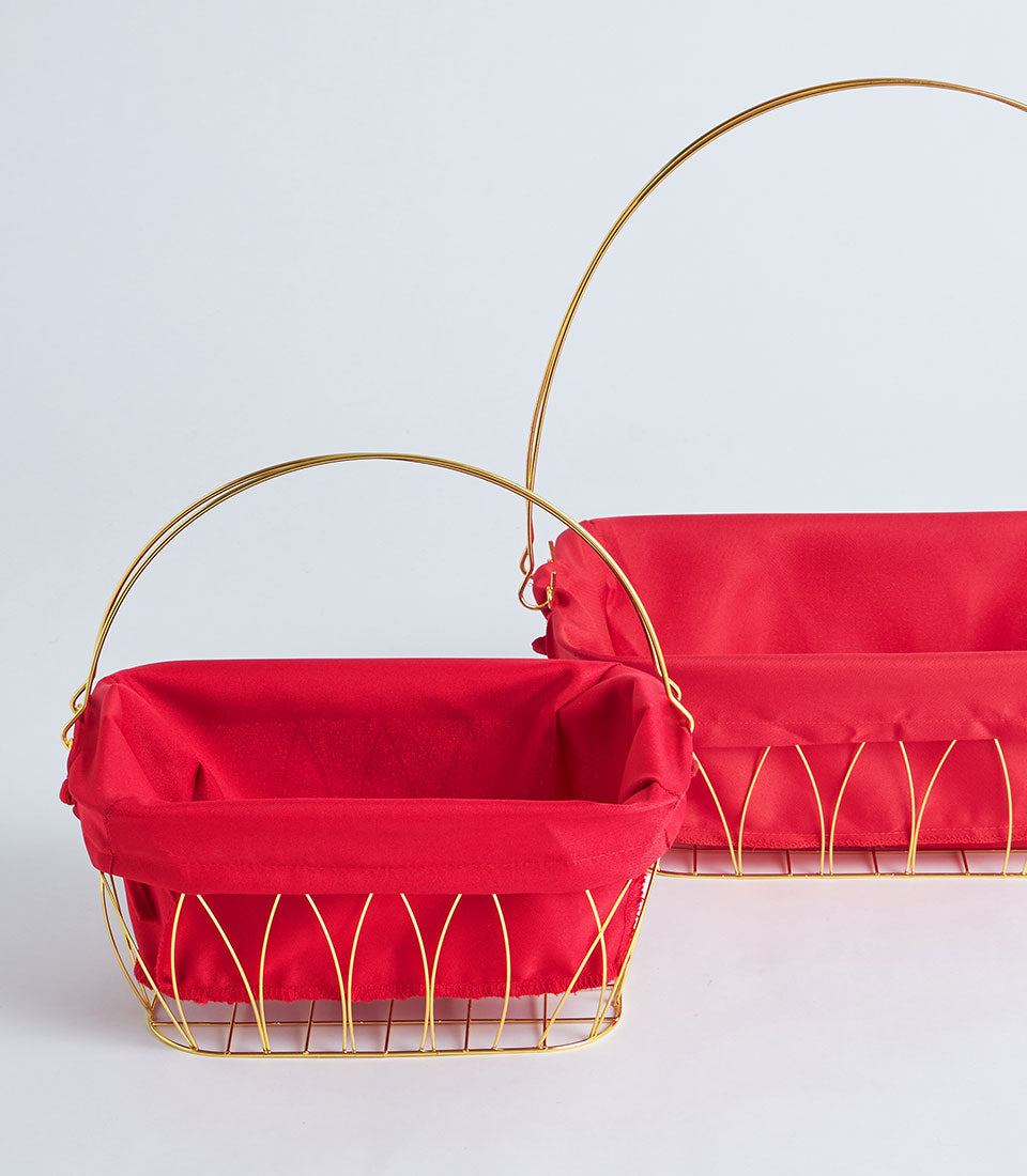 Gold metal wire basket with red fabric lining and curved handle, luxury gift hamper