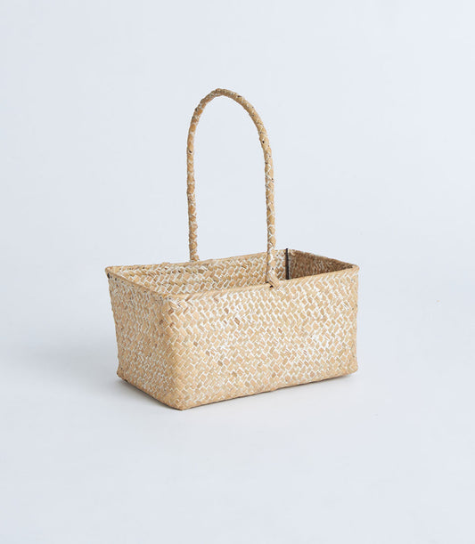Natural woven rectangular basket with handles, light tan seagrass design for artisan gift presentation