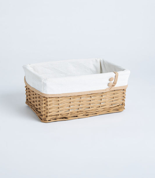 Luxurious handwoven wicker basket with a cream linen liner and charming button detail,