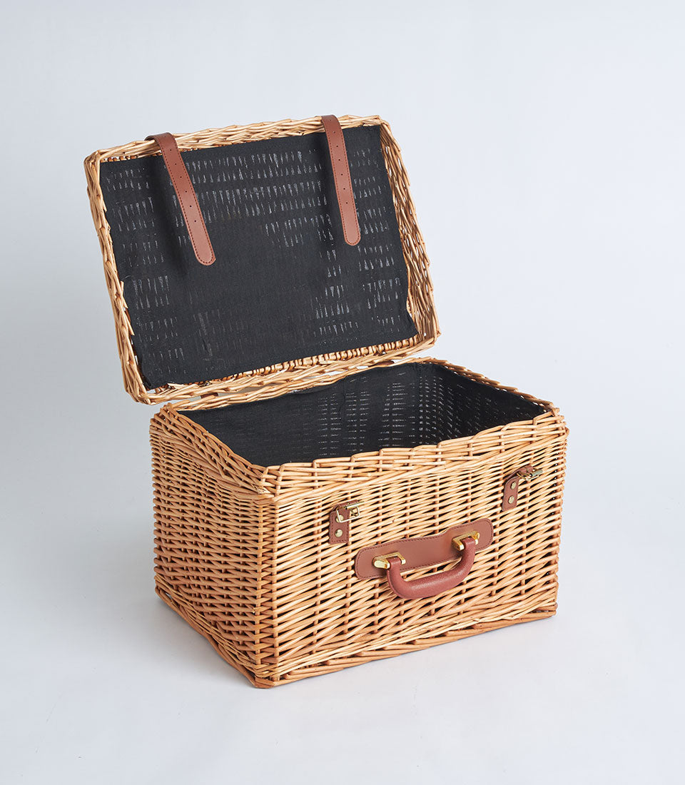 Natural wicker suitcase basket with black fabric lining and faux leather handle strap