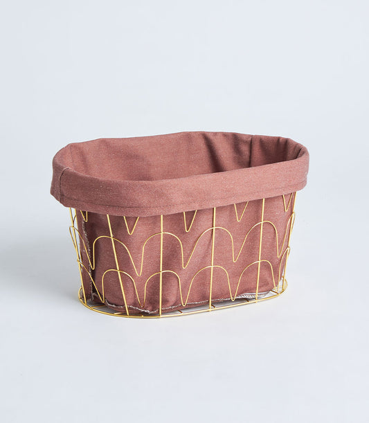 Round metal frame basket with gold handles and dusty rose fabric lining for luxury gift presentation