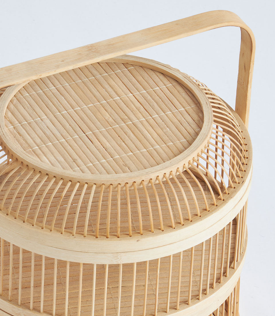 Natural bamboo two-tier serving basket with woven handle for elegant food gifting