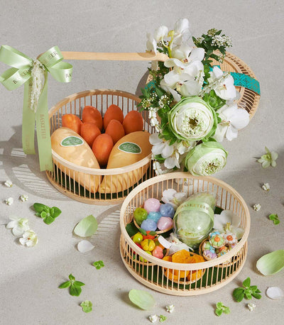 Songkran gift set with yellow mangoes, white orchids, and Thai sweets in wooden baskets