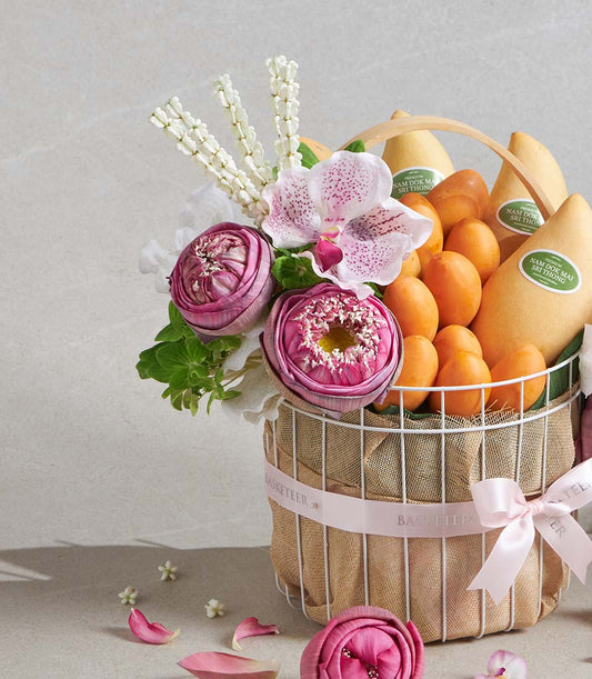 Premium mango and apricot gift basket with pink lotus flowers and orchids in natural burlap