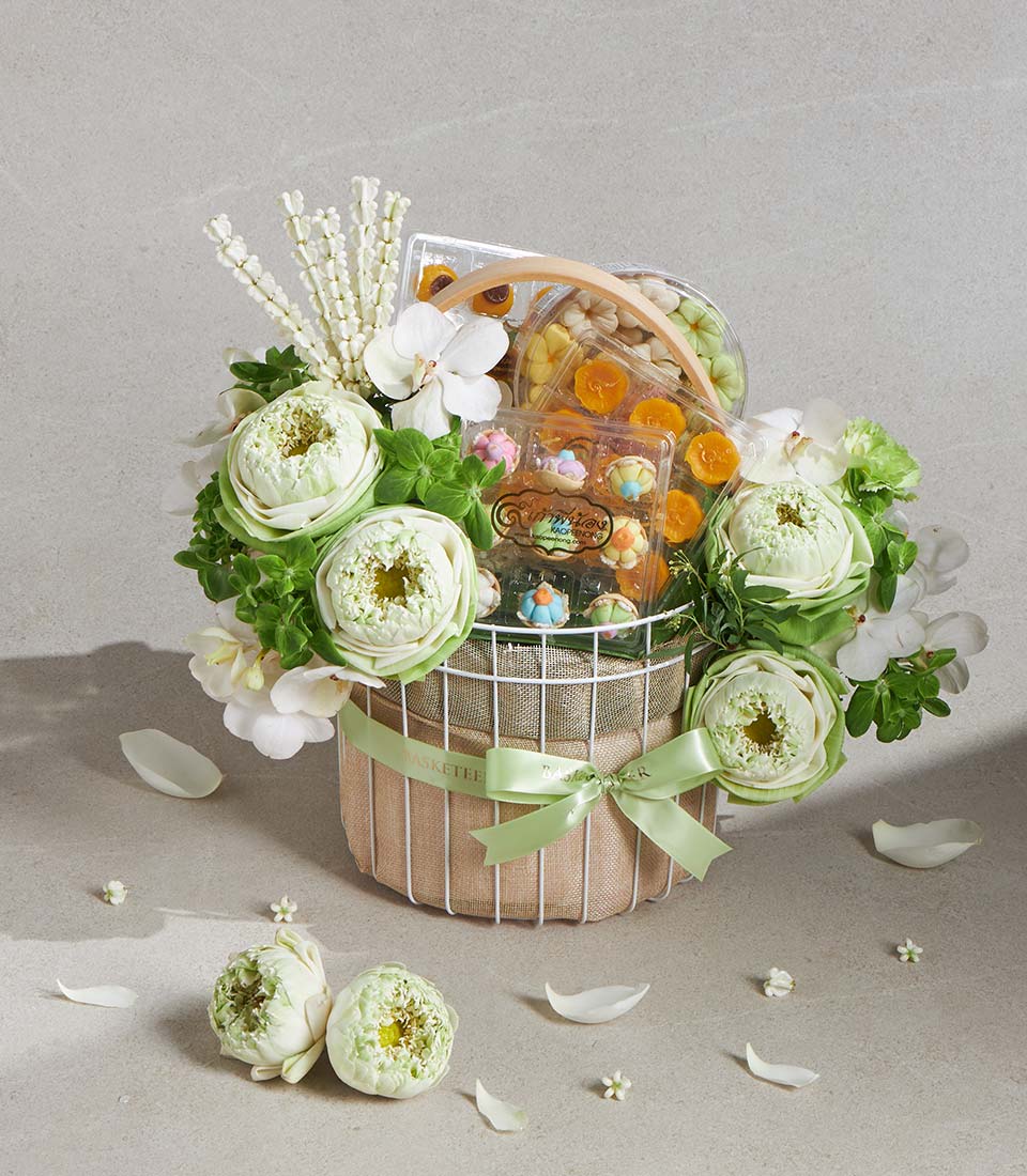 Lotus Blossom Serenity white wire gift basket with fresh lotus flowers, orchids, gourmet treats, and green satin ribbon