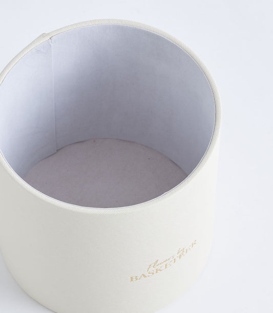 Luxurious ivory textured round gift box from Basketeer, featuring gold "Flowers