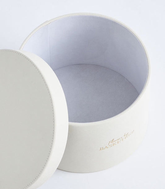 Luxurious Basketeer ivory gift box with textured finish and gold logo,