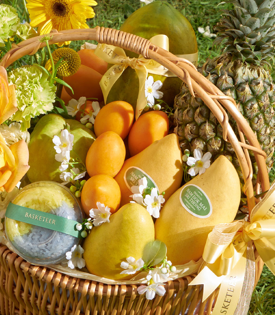 Sunlit Mango Garden gift basket with premium Nam Dok Mai mangoes, plums, guavas, pineapple, and tropical fruits in woven