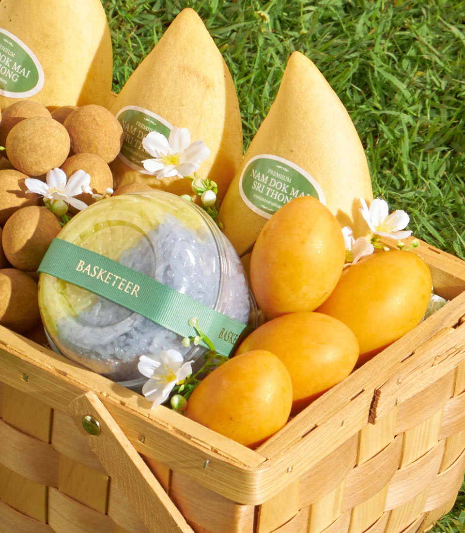 Premium longan, mango and Mayongchid tropical fruit gift basket in woven wood with white florals