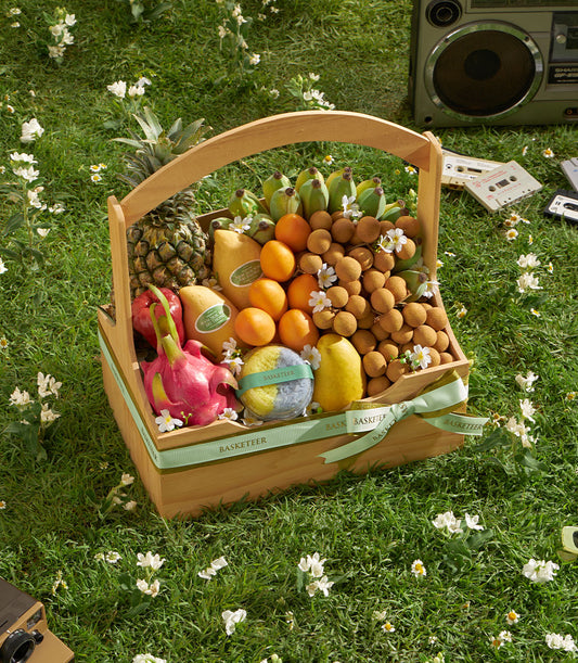 Premium Thai fruit basket with longan, mango, pineapple, and seasonal selection in woven wooden gift basket