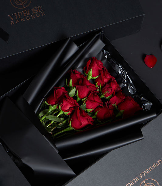 Luxury red rose bouquet in black gift box with gold branding, premium Valentine flowers from Ecuador