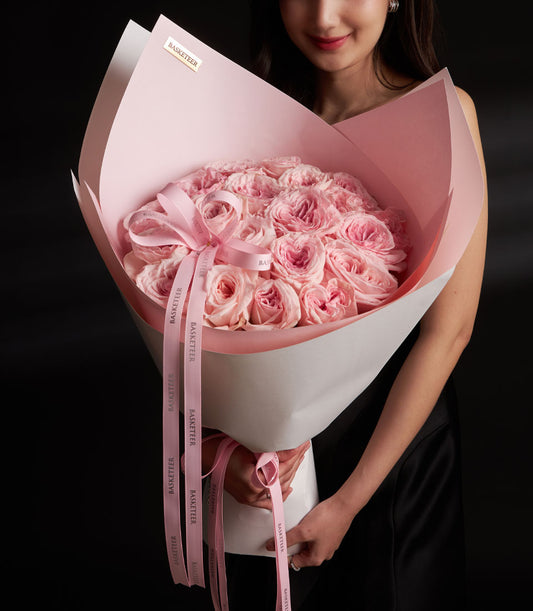 Large light pink O-Hara rose bouquet wrapped in blush and cream paper with pink Basketeer ribbons, luxury Valentine flowers