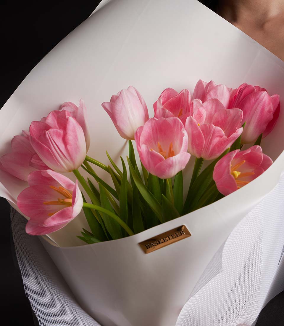 Premium pink tulip bouquet with white wrapping and green stems for Valentine's Day