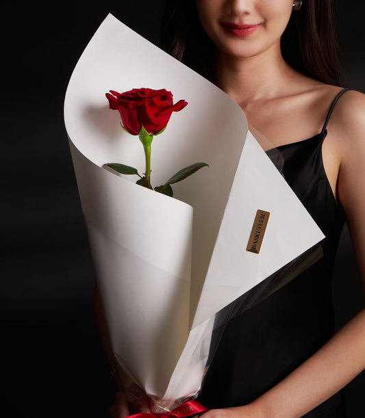 Elegant single red Explorer rose bouquet from Flowers by Basketeer, wrapped in white paper and tied with a red ribbon. Perfect for flower delivery Bangkok.
