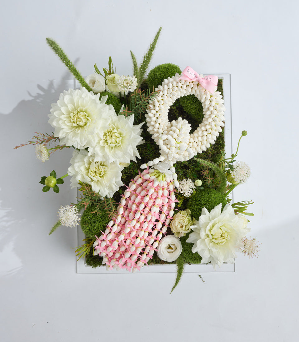 Luxury floral arrangement in white square box featuring white dahlias, pink hypericum berries, preserved moss, ornamental grasses, and delicate filler flowers.