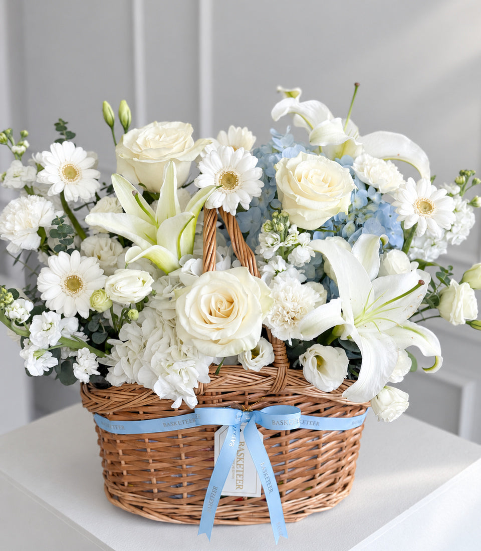 A luxurious Basketeer flower gift hamper with elegant white roses, lilies, and ger