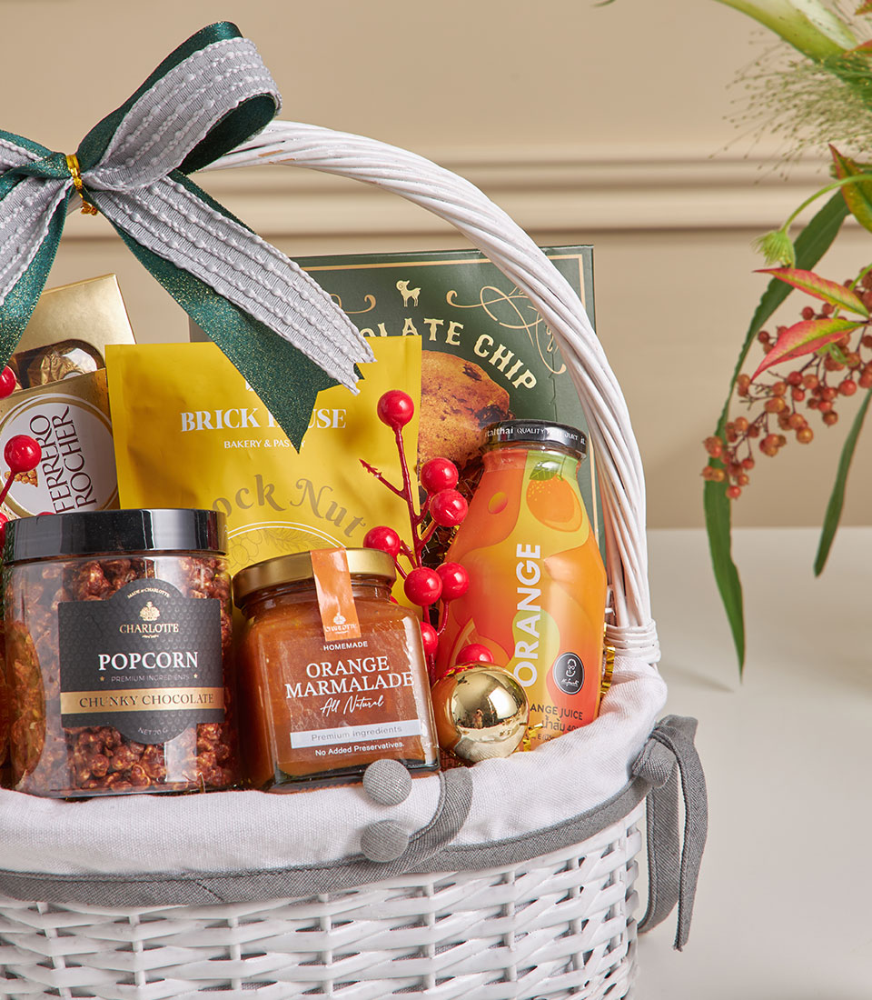 Premium New Year gift basket with chocolate chip cookies, gourmet popcorn, orange marmalade, and artisan treats in white