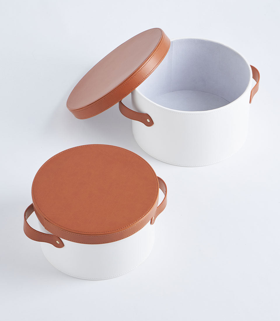Elegant Basketeer white round gift boxes with tan leather lids and handles,