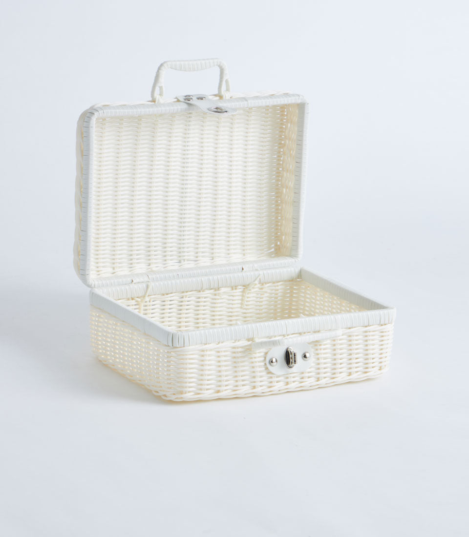 White wicker suitcase basket with silver clasp and handle, open and ready to fill