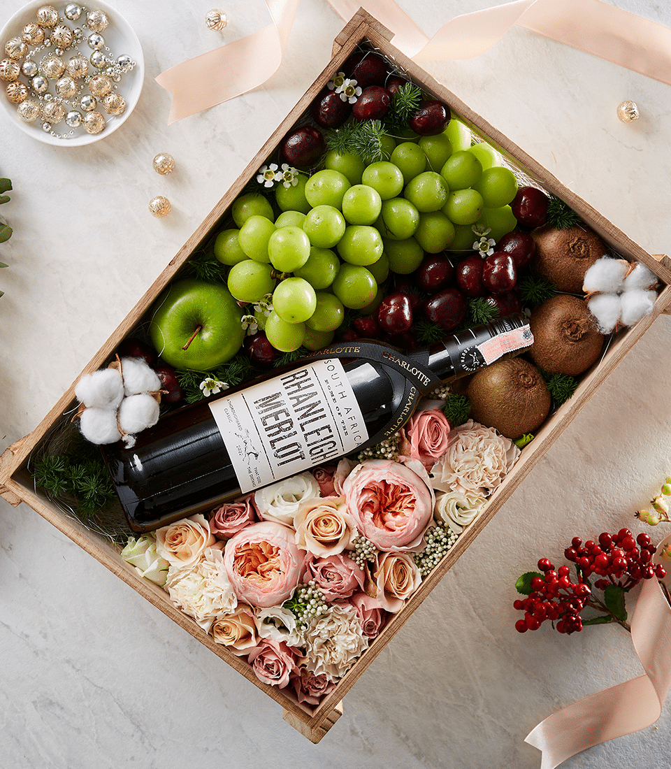 Luxury wine gift box with Rhanleigh Merlot, fresh grapes, kiwi, apple, and pink rose arrangement