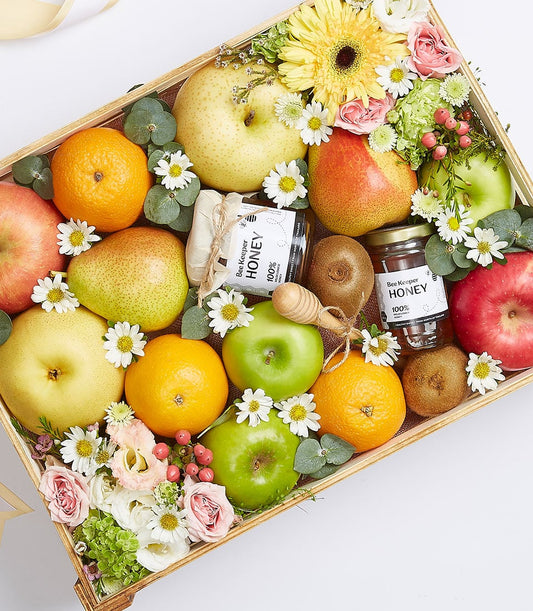 Deluxe wooden fruit gift box with fresh apples, pears, oranges, kiwis, honey products, and mixed flowers