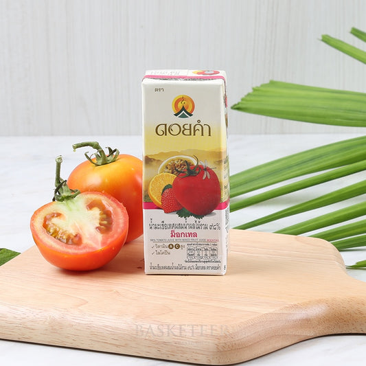 Fresh tomato and mixed fruit juice carton with whole and halved tomatoes on wooden board