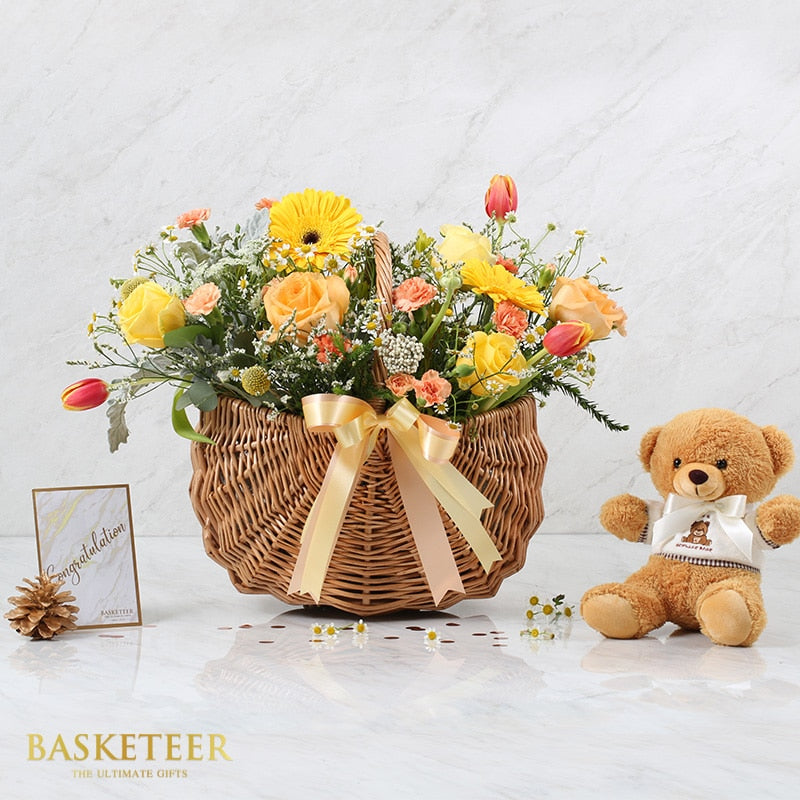Premium flower basket with yellow and orange roses, gerberas, tulips, and teddy bear gift set