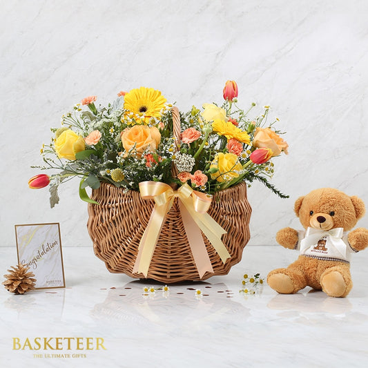 Premium flower basket with yellow and orange roses, gerberas, tulips, and teddy bear gift set