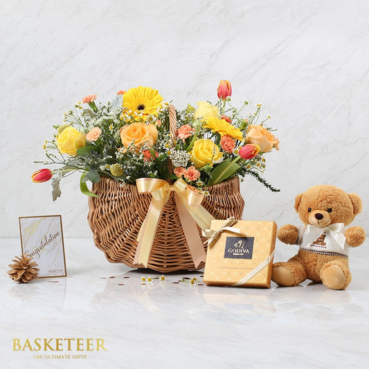 Luxury flower basket with yellow roses and gerberas, teddy bear, and chocolate gift set