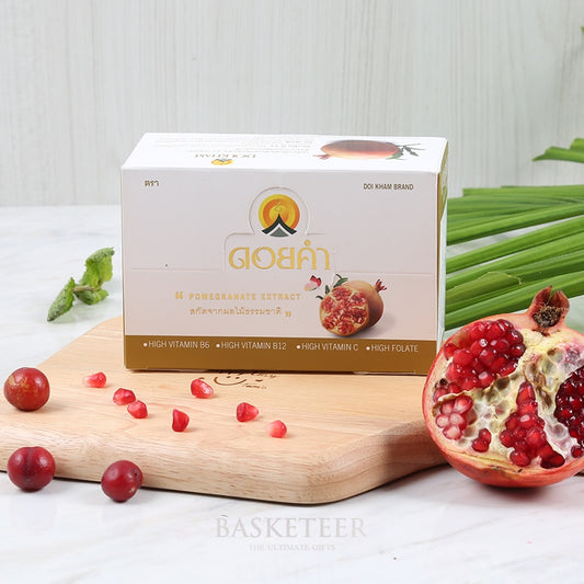 Pomegranate extract wellness box with red arils and vitamin-rich supplement package on wooden board