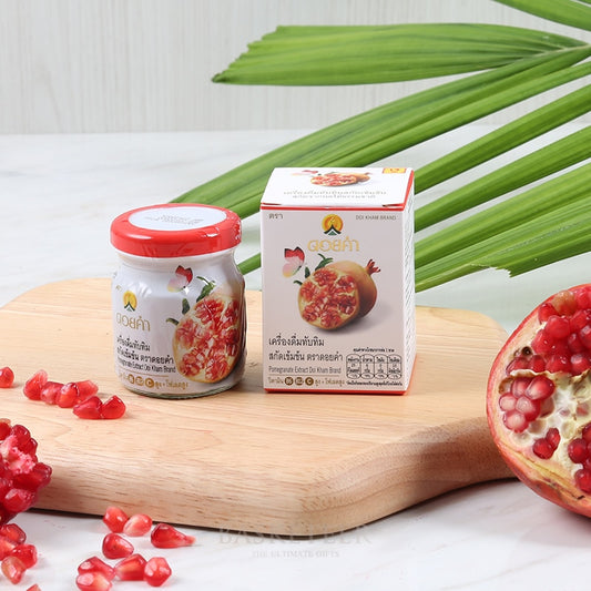 Premium pomegranate extract gift set with artisan jar and packaging on wooden board