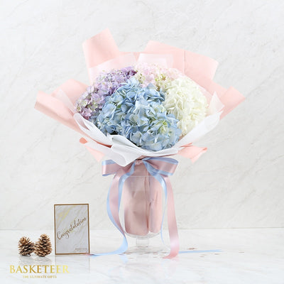 Pastel hydrangea bouquet in purple, blue, and white for birthday celebration
