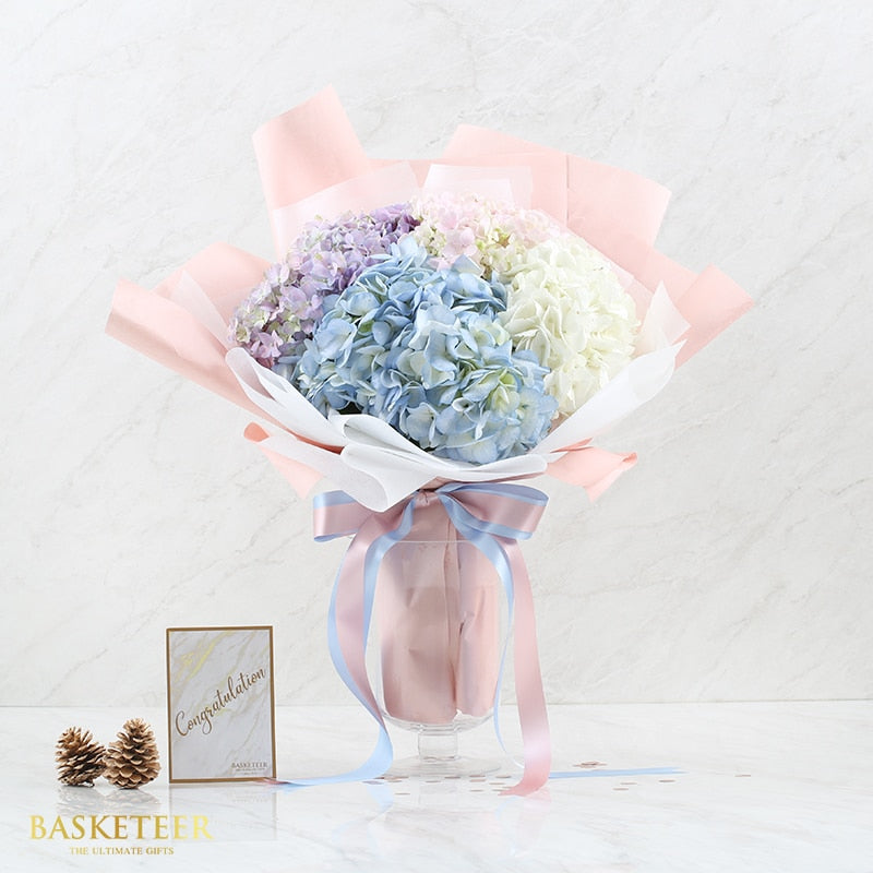 Pastel hydrangea bouquet in purple, blue, and white for birthday celebration
