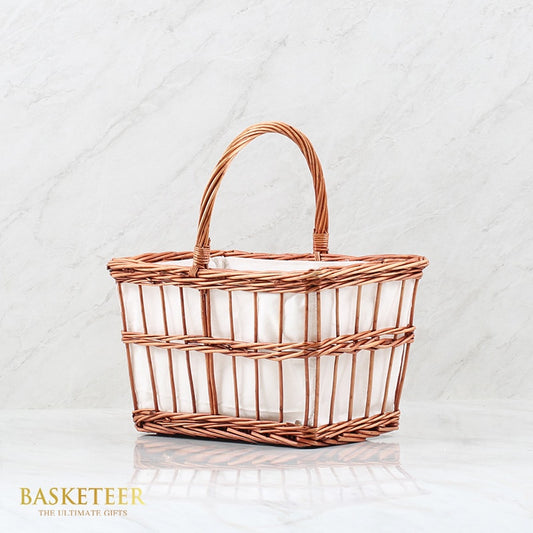 Light brown woven basket with white cloth lining and arched handle for premium gift presentation