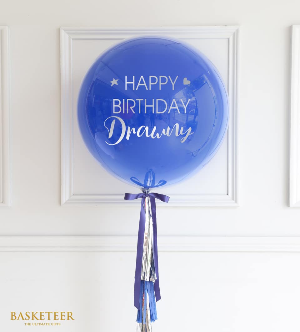 Blue Happy Birthday balloon with purple ribbon and metallic streamers, ready-to-gift celebration decoration